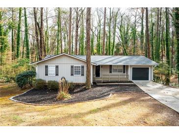 Charming single-story home featuring a well-manicured front yard and an attached one car garage at 5000 Northland Sw Rd, Mableton, GA 30126