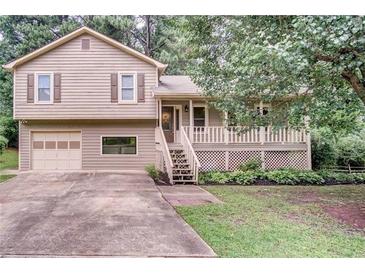 Charming two-story home with a well-maintained lawn and a cozy front porch at 7060 Steel Wood Nw Dr, Kennesaw, GA 30152