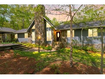 Charming home with stone accents, lovely landscaping, and a welcoming front entrance at 175 Flat Creek Ct, Fayetteville, GA 30214
