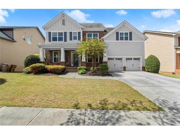 Charming two-story home featuring a well-manicured lawn, landscaped beds, and a two-car garage at 2238 Well Springs Dr, Buford, GA 30519