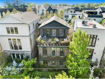 Charming multi-story home boasts brick facade, lush greenery, and multiple outdoor spaces at 558 Bismark Ne Rd, Atlanta, GA 30324
