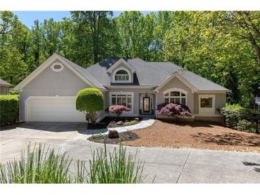 Charming single-Gathering home with a well-manicured front yard and an attached two-car garage at 220 Autumn Sage Dr, Alpharetta, GA 30005