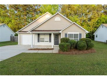 Charming single-story home featuring well-maintained landscaping and a cozy front porch at 191 Misty Ridge Trl, Stockbridge, GA 30281