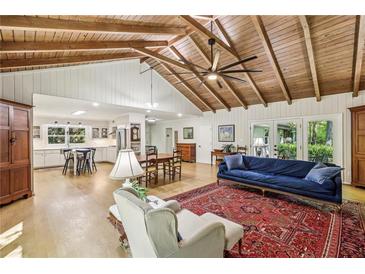Spacious living room with hardwood floors, vaulted wood ceilings, and open floor plan at 3311 Stillhouse Se Rd, Atlanta, GA 30339