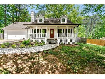 Charming home with a welcoming front porch and well-manicured landscaping at 385 Russell Ridge Dr, Lawrenceville, GA 30043