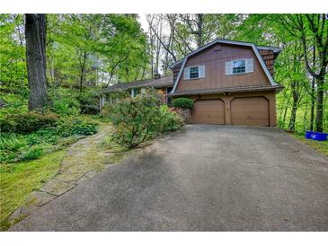 Inviting two-story home with a two car garage, surrounded by lush greenery at 2520 Overlook Ne Way, Atlanta, GA 30345
