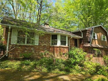 Charming brick home with mature landscaping and a unique architectural design nestled in a wooded setting at 2520 Overlook Ne Way, Atlanta, GA 30345