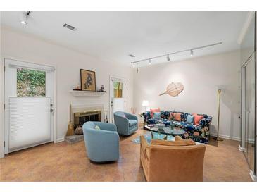 Inviting living room with fireplace, tile floors, and bright, neutral decor at 5180 Chemin De Vie, Atlanta, GA 30342