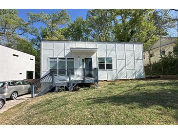 Modern home with a stylish exterior, featuring a charming front porch and landscaped yard at 952 Bruce Se Cir, Atlanta, GA 30316
