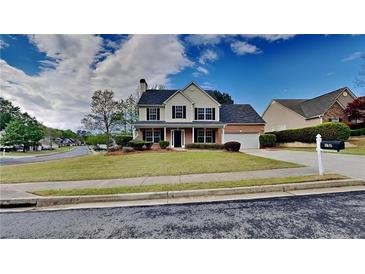 Charming two-story home with a well-manicured lawn and traditional architecture at 132 Garden Manor Ct, Loganville, GA 30052