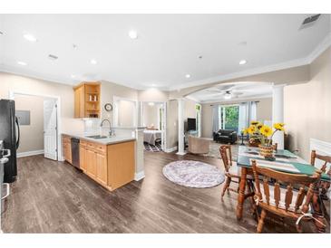 Open-concept living and kitchen area with hardwood floors and lots of natural light at 2103 Stratford Commons, Decatur, GA 30033