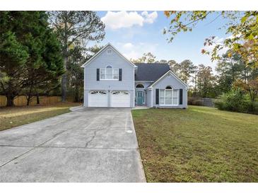 Charming two-story home with blue siding, double garage, and well-maintained front yard at 3568 Foxworth Ct, Buford, GA 30519