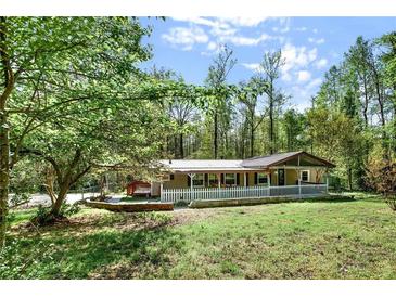 Charming single-story home with a large yard, mature trees, and inviting front porch at 4653 Anns Se Trce, Acworth, GA 30102
