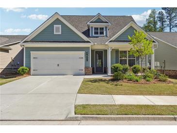 Charming home featuring a two-car garage, manicured lawn, and inviting front porch at 2526 Knob Creek Dr, Snellville, GA 30078