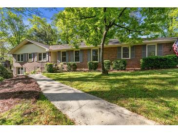 Charming brick home with well-maintained landscaping and a sidewalk leading to the entrance at 3982 Battleford Ct, Atlanta, GA 30341
