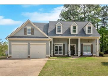 Charming two-story home with a well-manicured lawn, two car garage and inviting front porch at 17 Brightwater Cv, Dallas, GA 30157