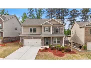 Charming two-story home with brick and siding exterior, landscaped yard, and a two-car garage at 4531 Claiborne Ct, Duluth, GA 30096