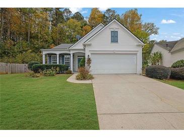 Charming single-story home featuring a well-manicured lawn and a two-car garage at 3401 Ravensworth Trce, Kennesaw, GA 30144