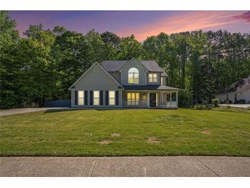 Charming two-story home boasts a beautifully landscaped front yard and inviting front porch at 2023 Reserve Pkwy, Mcdonough, GA 30253