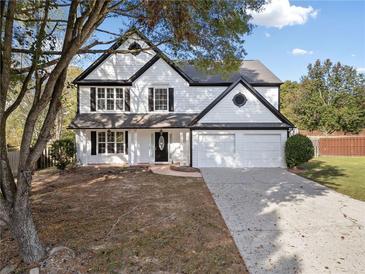 Charming two-story home with a well-manicured front yard, two car garage, and classic white siding at 946 Steadman Ter, Marietta, GA 30064