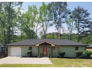 Charming single-story home with a cozy front porch and well-maintained landscaping surrounded by mature trees at 2007 Mesa Se Dr, Atlanta, GA 30316