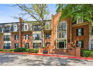 Elegant brick building featuring a grand arched window entrance and landscaped grounds at 23310 Plantation Ne Dr, Atlanta, GA 30324