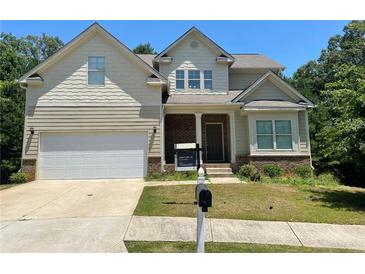 Charming two-story home featuring a brick-accented facade, attached garage, and a well-maintained front yard at 4346 Traipse Path, Ellenwood, GA 30294