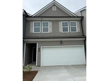 Two-story home featuring gray siding, a white garage door, and complementary light gray window shutters at 1120 Edinberg Dr # 61, Villa Rica, GA 30180
