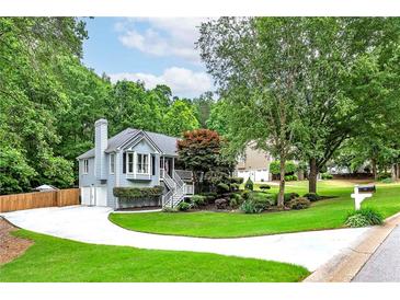 Charming home featuring beautiful landscaping, bay window, and a well-manicured lawn at 489 Warrenton Dr, Douglasville, GA 30134