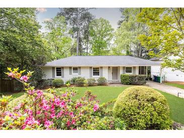 Charming brick home with a well-maintained front yard and colorful azalea bushes at 1295 Lindenwood Ne Ln, Brookhaven, GA 30319