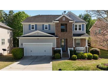 Charming two-story home with a brick facade and well-manicured lawn at 985 Forest Knoll Court, Lithia Springs, GA 30122