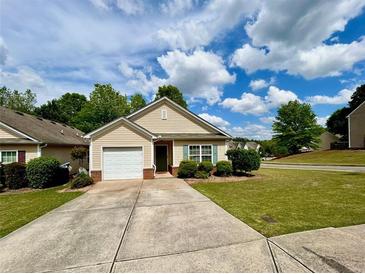 Charming home with manicured lawn, driveway, and a one-car garage under a blue sky at 320 Little Creek Rd, Lawrenceville, GA 30045