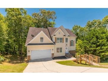 Charming two-story home with landscaped yard, inviting walkway, and attached two-car garage at 1850 Brooks Pointe Ct, Lawrenceville, GA 30045
