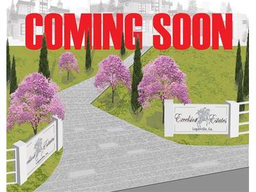 Estate entrance with a paver driveway, lush landscaping, and a neighborhood sign that says 'Excelsior Estates' at 1906 Knight Cir, Loganville, GA 30052