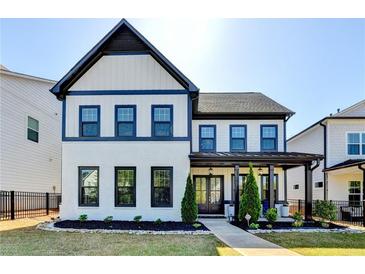 Stunning two-story home with black trim, well-manicured lawn, and inviting entrance at 3364 Old Concord Se Rd, Smyrna, GA 30082