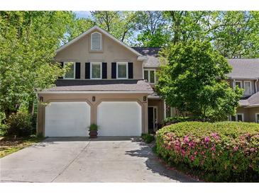 Charming two-story home featuring a two-car garage, well-maintained landscaping, and inviting curb appeal at 403 S River Farm Dr, Alpharetta, GA 30022