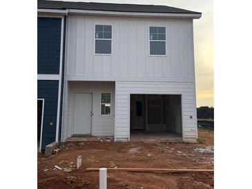 Charming home exterior featuring white siding, an attached garage, and a welcoming entrance at 1344 Riverstone Rd # 108, Jonesboro, GA 30238