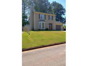 Charming two-story home with manicured lawn and attached garage at 2044 Mallard Crest, Lithonia, GA 30058