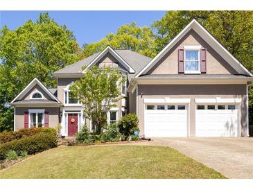 Charming two-story home with a well-manicured lawn and attached two-car garage at 4016 Upland Trce, Marietta, GA 30066