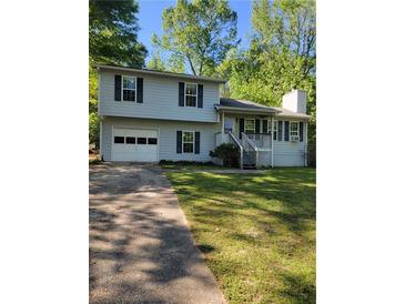 Charming two-story home with a one-car garage and well-maintained front yard at 4775 Ben Hill Rd, Douglasville, GA 30134