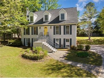 Charming two-story brick home with a meticulously maintained lawn and mature trees at 3200 Hampton Ridge Way, Snellville, GA 30078