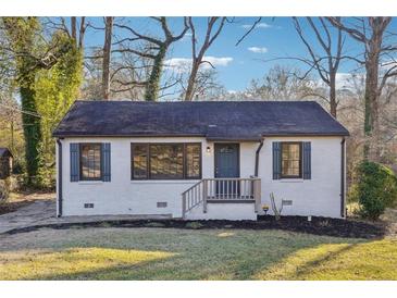 Charming single-story home with a freshly painted exterior and a well-maintained front yard at 1870 Oak Valley Rd, Decatur, GA 30035