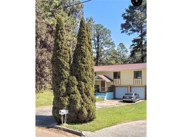 Charming two-story home featuring a welcoming entrance, two-car garage, and well-maintained lawn at 1764 Big Valley Way, Stone Mountain, GA 30083