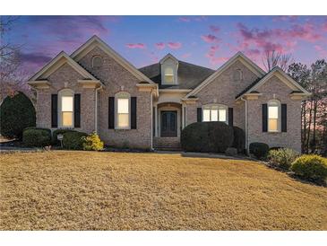Charming single-story brick home featuring manicured lawn and tasteful landscaping, creating inviting curb appeal at 1837 Miramonte Way, Lawrenceville, GA 30045