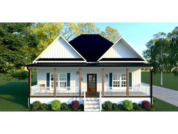 Charming one-story white farmhouse with black roof, covered porch and manicured front yard at 95 Rome St, Temple, GA 30179