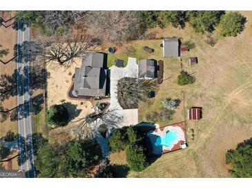 Expansive property showcasing a charming home with a private pool, outbuildings and generous acreage at 813 Sandy Creek Rd, Fayetteville, GA 30214