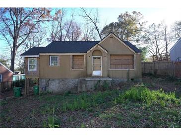 Exterior shot of an older home with tan siding and newer roof at 2055 Marco Dr, Decatur, GA 30032