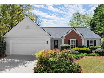 Charming single-story home featuring a brick accent, manicured landscaping and an attached two-car garage at 5755 Haterleigh Dr, Alpharetta, GA 30005
