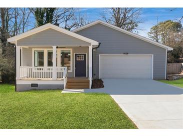 Charming gray house with a welcoming porch and a two-car garage, surrounded by well-maintained green lawn at 2195 Springdale Sw Rd, Atlanta, GA 30315
