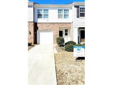 Charming two-story townhome with a one-car garage and well-maintained front yard at 6408 Kennonbriar Ct, Lithonia, GA 30058